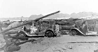 Burned-out cars on the beach after the 1936 Bandon fire