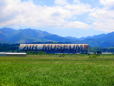 The old blimp hangar, one of several identical structures that are the largest clear-span wood buildings in the world, as seen from Highway 101. World War II-era blimp hangar near Tillamook, home of the Tillamook Air Museum, shares the title of "largest clear-span wooden building" with several other blimp hangars of the same design.