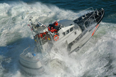 A modern 47-foot motor lifeboat, the direct descendant of the battered lifeboat found on the beach by Joel Munson in 1865. Modern 47-foot motor lifeboat on the Columbia River bar.