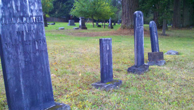 From near to far, these markers are for John Porter, Elsie Porter, Mary Porter, the younger Mary Porter and family slave Ame. From near to far, these markers are for John Porter, Elsie Porter, Mary Porter, the younger Mary Porter and family slave Ame.