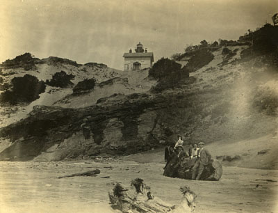 The abandoned and neglected Yaquina Bay Light as seen from the beach around five years after Lischen Miller wrote “The Haunted Light.” The view of the Yaquina Bay Lighthouse from the beach, circa 1905.