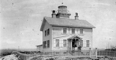 An image from the 1880s or 1890s of Yaquina Head Lighthouse a few years after it was decommissioned and replaced with the nearby Yaquina Head lighthouse. This very old photograph dates from just after the lighthouse was replaced by the Yaquina Head lighthouse.