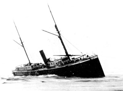 The stranded S.S. Yaquina City sits in the surf on the north side of the Yaquina Bay entrance. The pounding surf destroyed the big steamer in short order. The stranded S.S. Yaquina City wallowing on the beach north of the Yaquina Bay entrance.