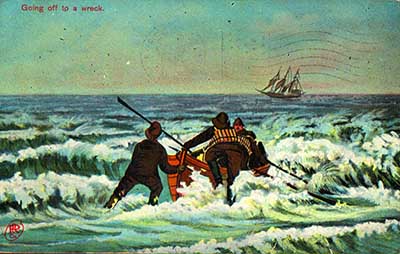 A vintage postcard image from the turn of the 20th century, showing a crew of rescuers launching a surfboat to go to the aid of a foundering schooner.
