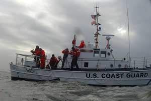 The crew of the 52-foot motor lifeboat Triumph II lays a wreath in the sea where five members of the crew of the first Triumph died, on the Columbia River Bar. The Triumph II is a completely different boat design.