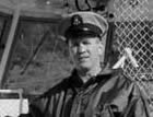 Master Chief Thomas McAdams at the helm of one of the Coast Guard boats. McAdams participated in more than 5,000 rescues, and personally saved at least 100 people from drowning.