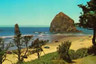 Haystack Rock and Cannon Beach as seen in a postcard image from 1966. When this photo was made, the fences, cabanas, lounge furnishings and "no trespassing" signs were on the beach to the right of the area shown in this picture.