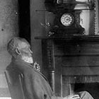 Former slave Louis Southworth relaxes at his home; the violin with which he earned his freedom is perched atop the clock on the mantle.
