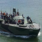 The fully restored PT-658 as seen from the sidewalk on the Hawthorne Bridge during the 2011 Rose Festival. On this occasion, the PT-658 inadvertently intruded into the dragonboat races, which were then in progress, and quickly retreated back downriver – but not before giving the dragonboat-racing spectators on the bridge a spectacular view of its deck armaments. (Image: F.J.D. John)